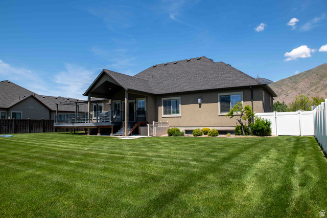 646 East 1400th Street North Mapleton, UT 84664 - Photo 64 of 78 Expansive backyard featuring a manicured lawn, covered patio, and composite decking with glass railings