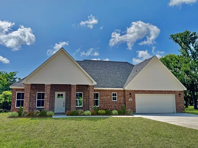 a front view of house with yard and green space