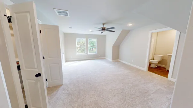 an empty room with windows and closet