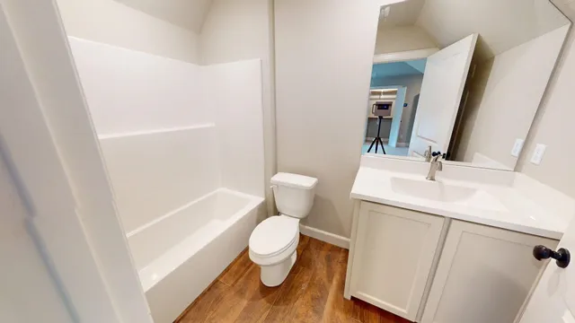 a white toilet sitting next to a bathroom sink
