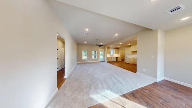 a view of hallway with wooden floor