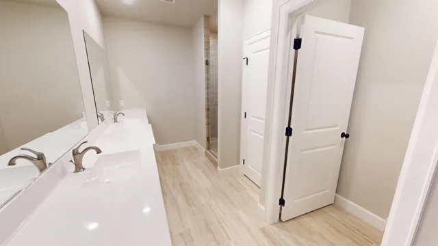 a kitchen with a sink cabinets and wooden floor