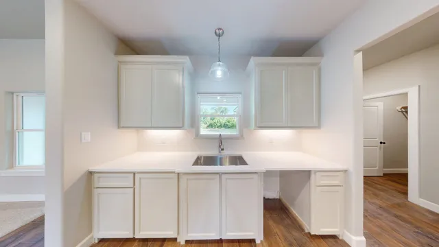 a spacious bathroom with a tub sink and mirror