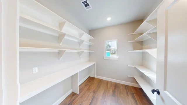 a view of a hallway with wooden floor and entryway