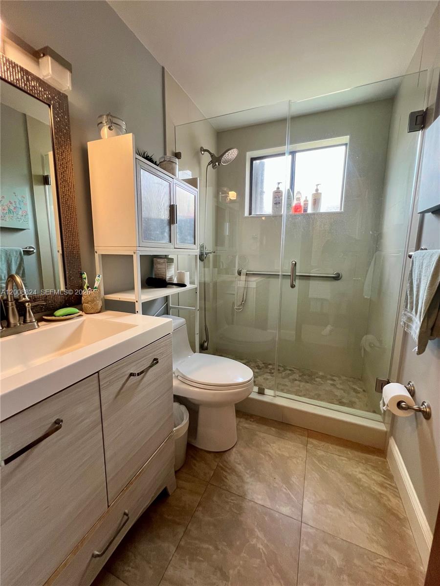 3610 Southwest 113th Place Miami, FL 33165 - Photo 11 of 49 a bathroom with a double vanity sink toilet and shower