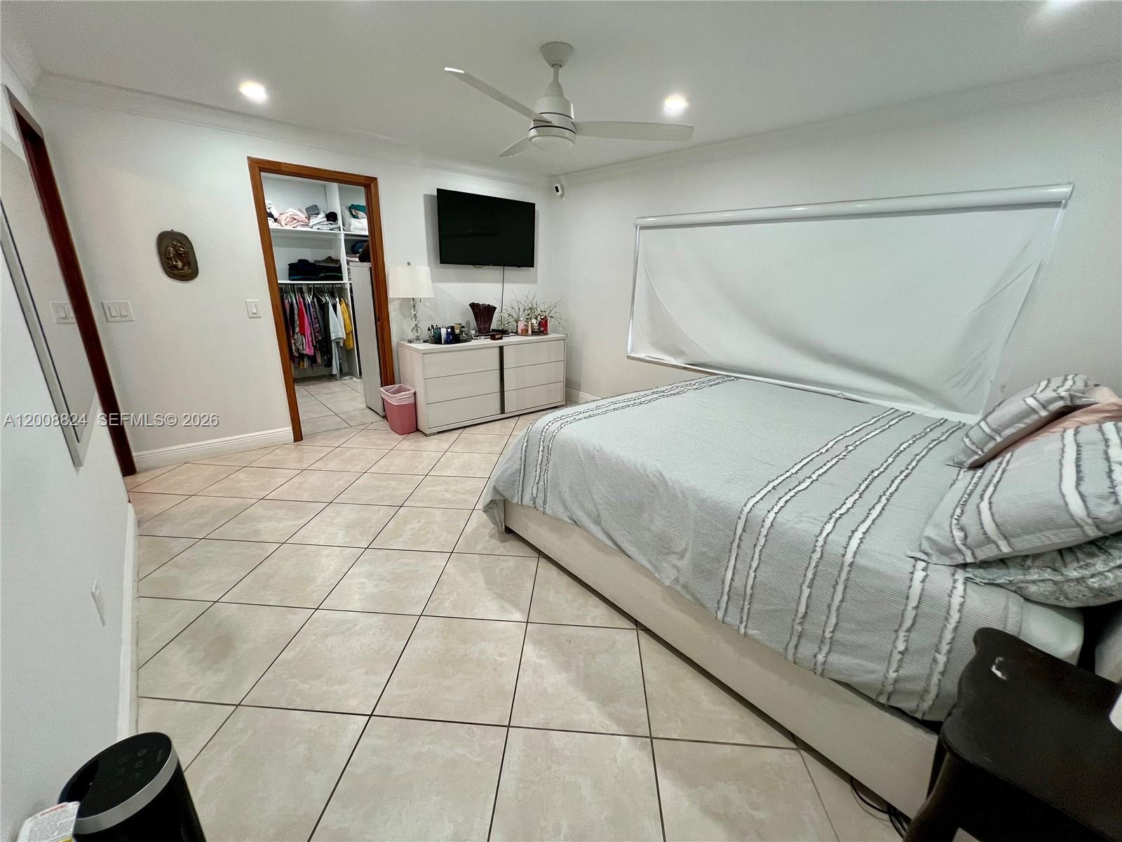 3610 Southwest 113th Place Miami, FL 33165 - Photo 16 of 49 a spacious bedroom with a bed and a flat screen tv