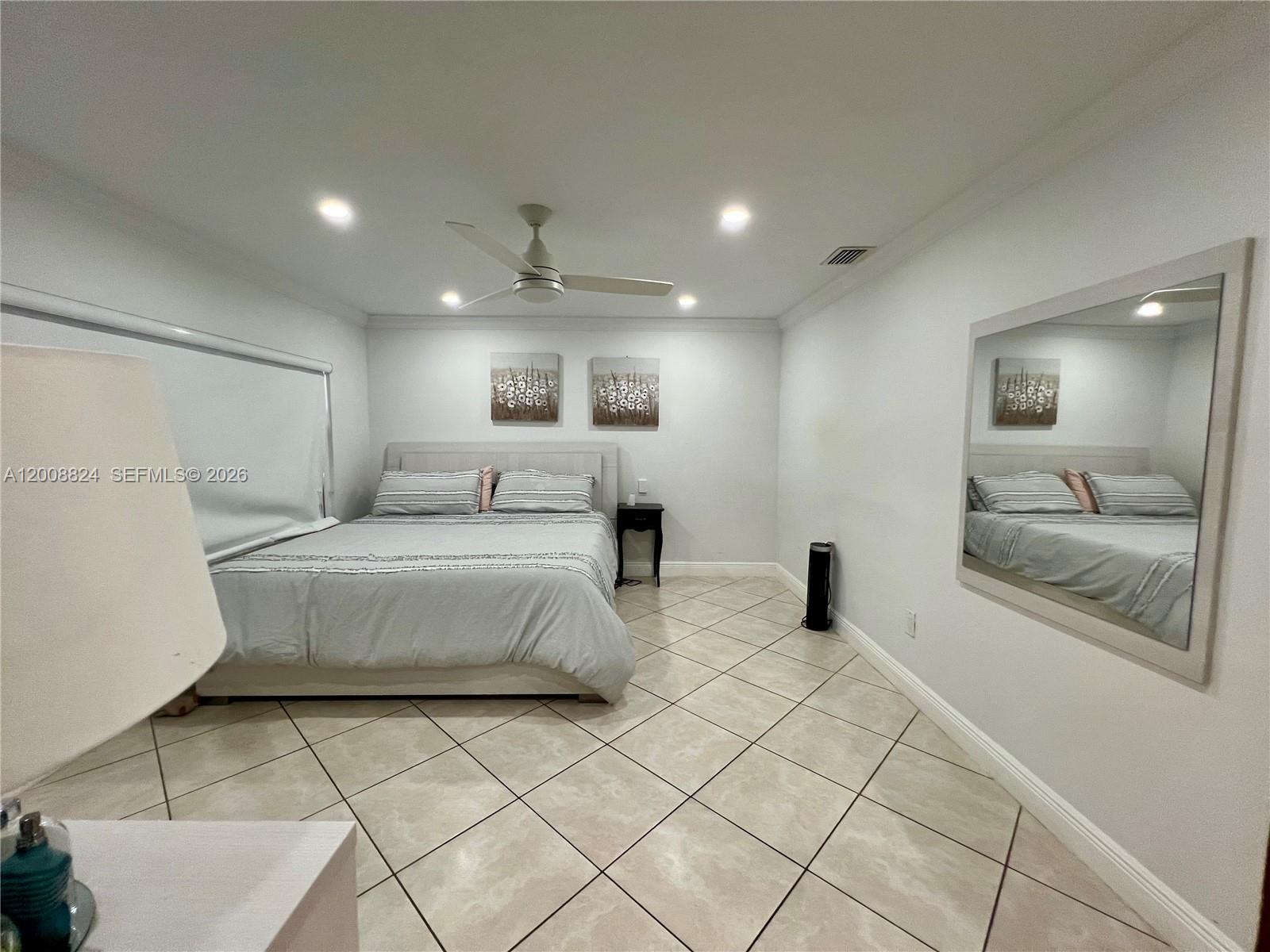 3610 Southwest 113th Place Miami, FL 33165 - Photo 17 of 49 a spacious bedroom with a large bed and a large window