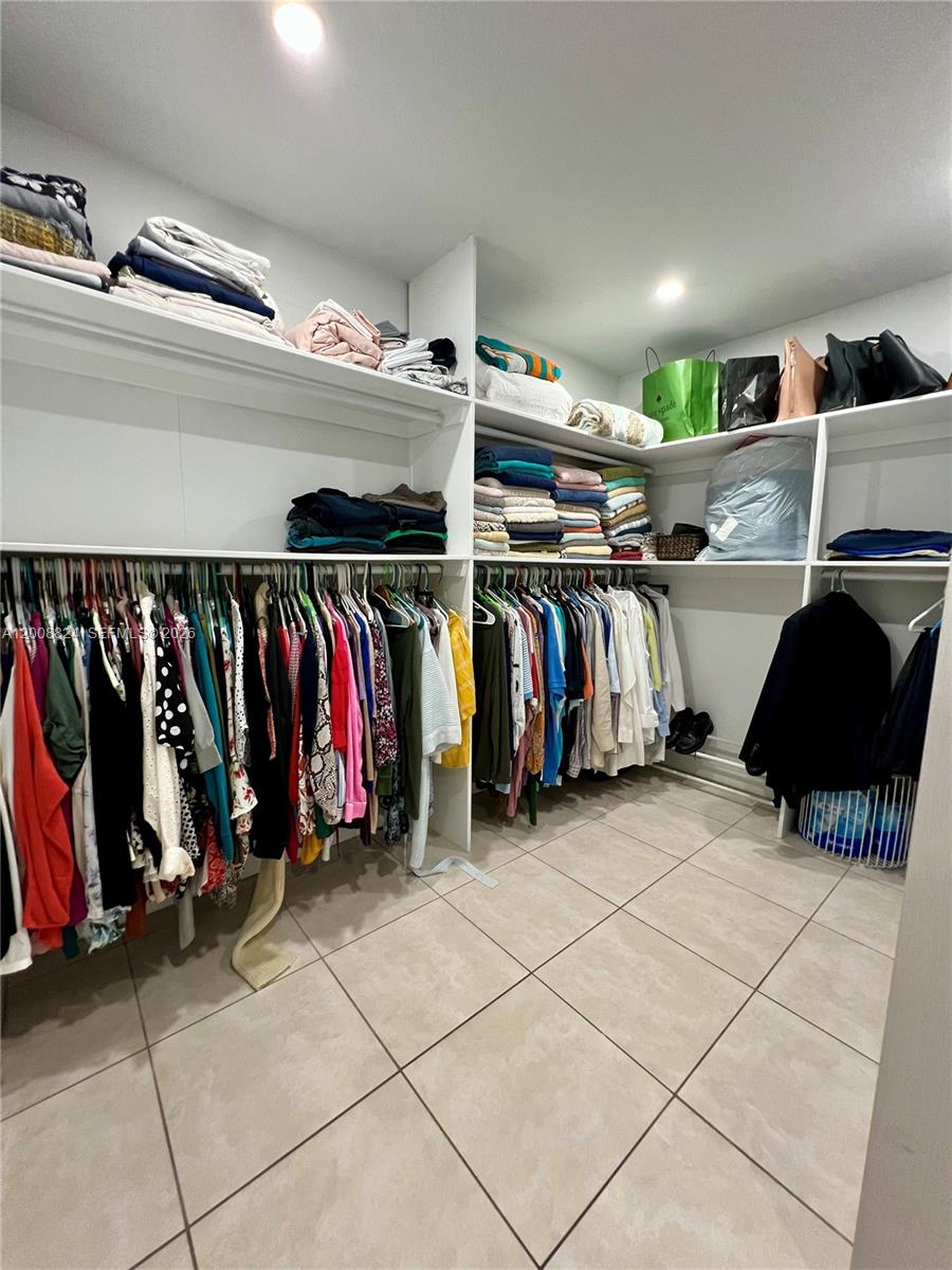 3610 Southwest 113th Place Miami, FL 33165 - Photo 18 of 49 a view of walk in closet with clothes and shoes