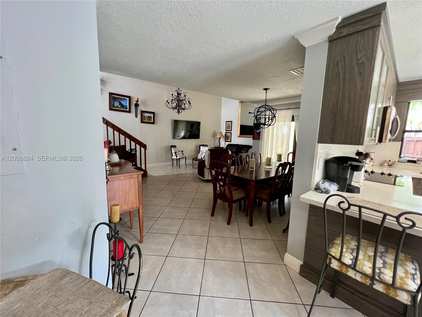 3610 Southwest 113th Place Miami, FL 33165 - Photo 21 of 49 a view of a livingroom with furniture and a flat screen tv