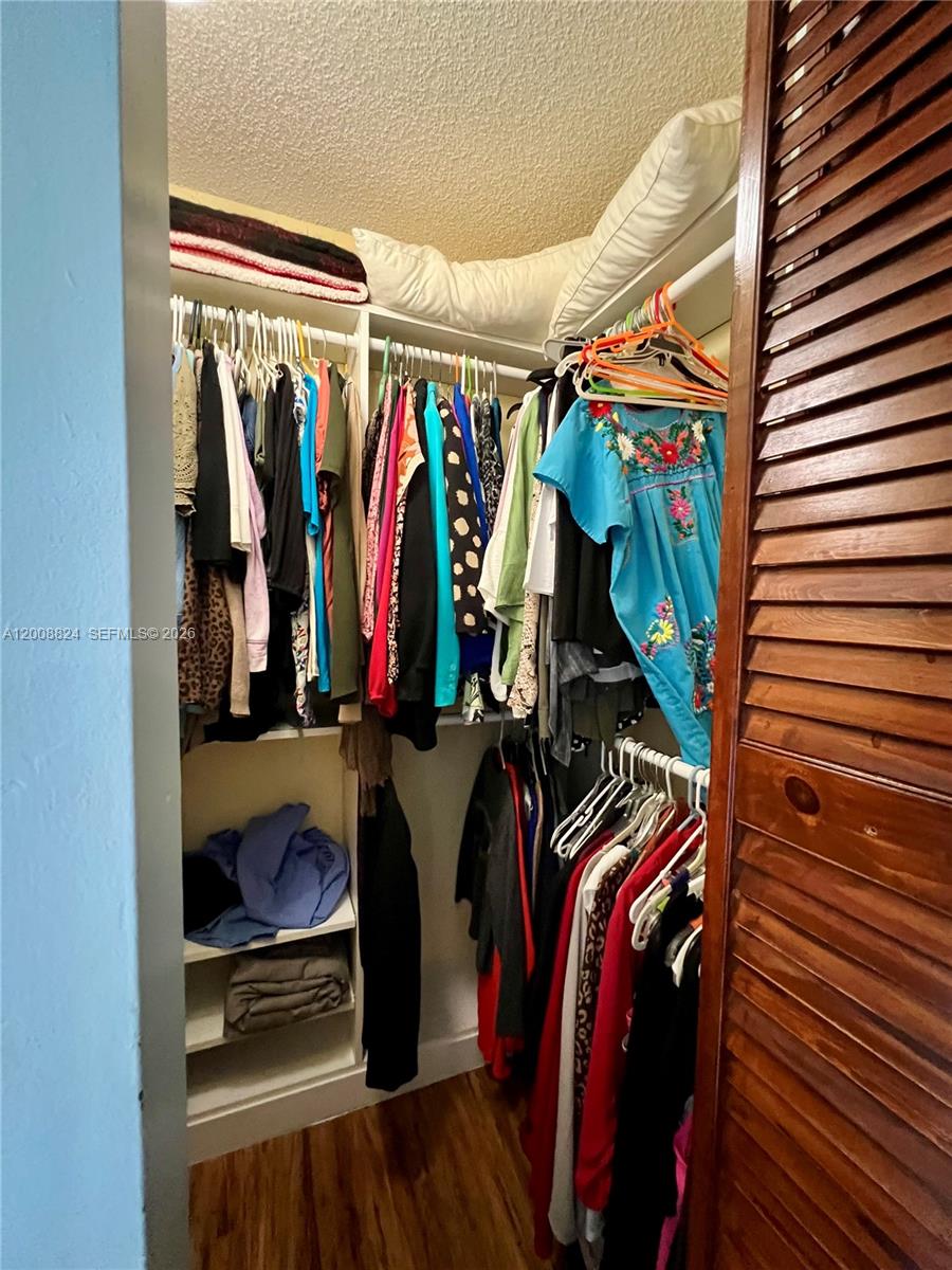 3610 Southwest 113th Place Miami, FL 33165 - Photo 27 of 49 a view of walk in closet with clothes and shoes