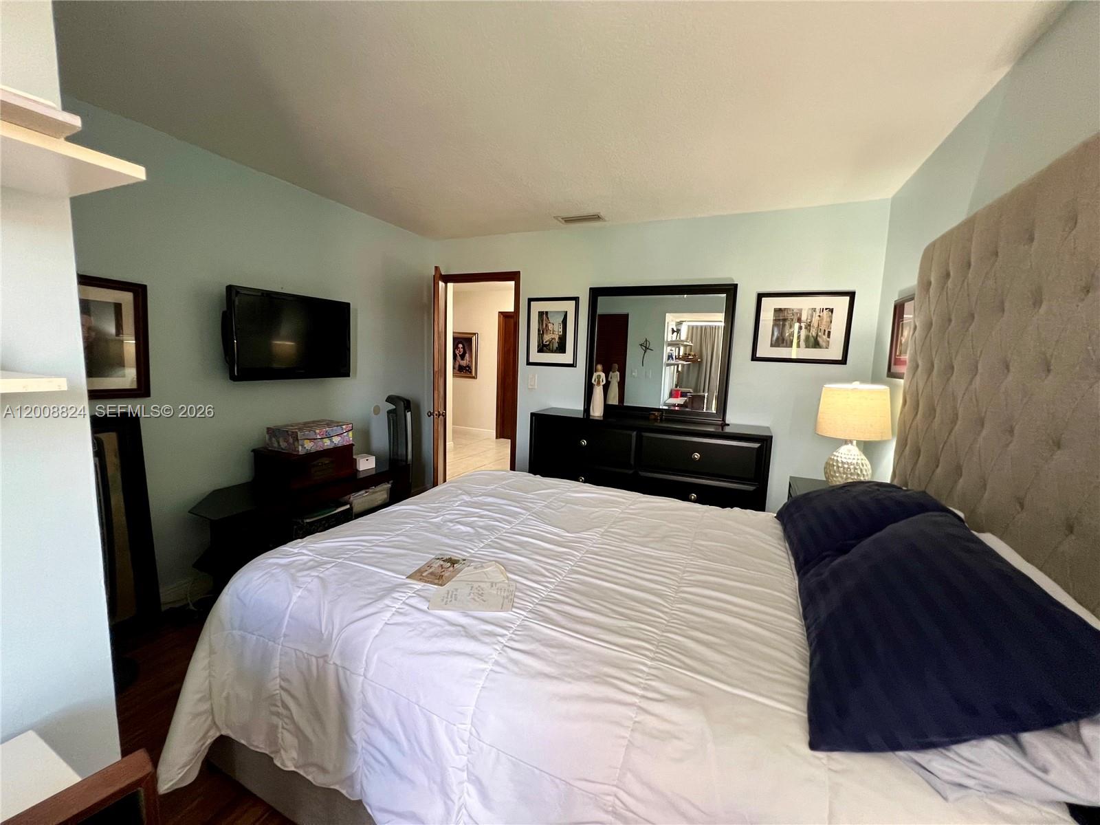3610 Southwest 113th Place Miami, FL 33165 - Photo 28 of 49 a bedroom with a bed and a flat screen tv