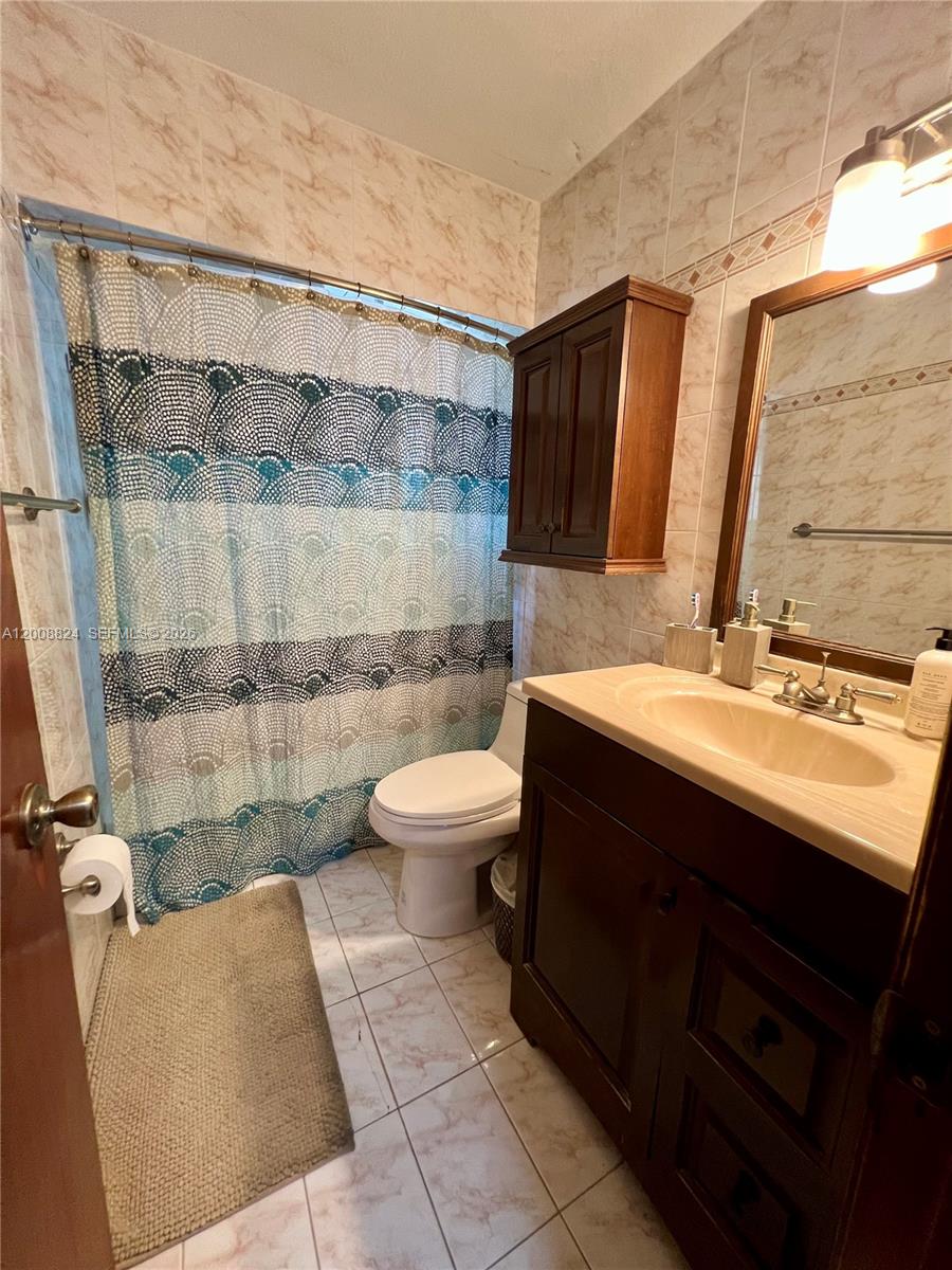3610 Southwest 113th Place Miami, FL 33165 - Photo 29 of 49 a bathroom with a sink a toilet and shower