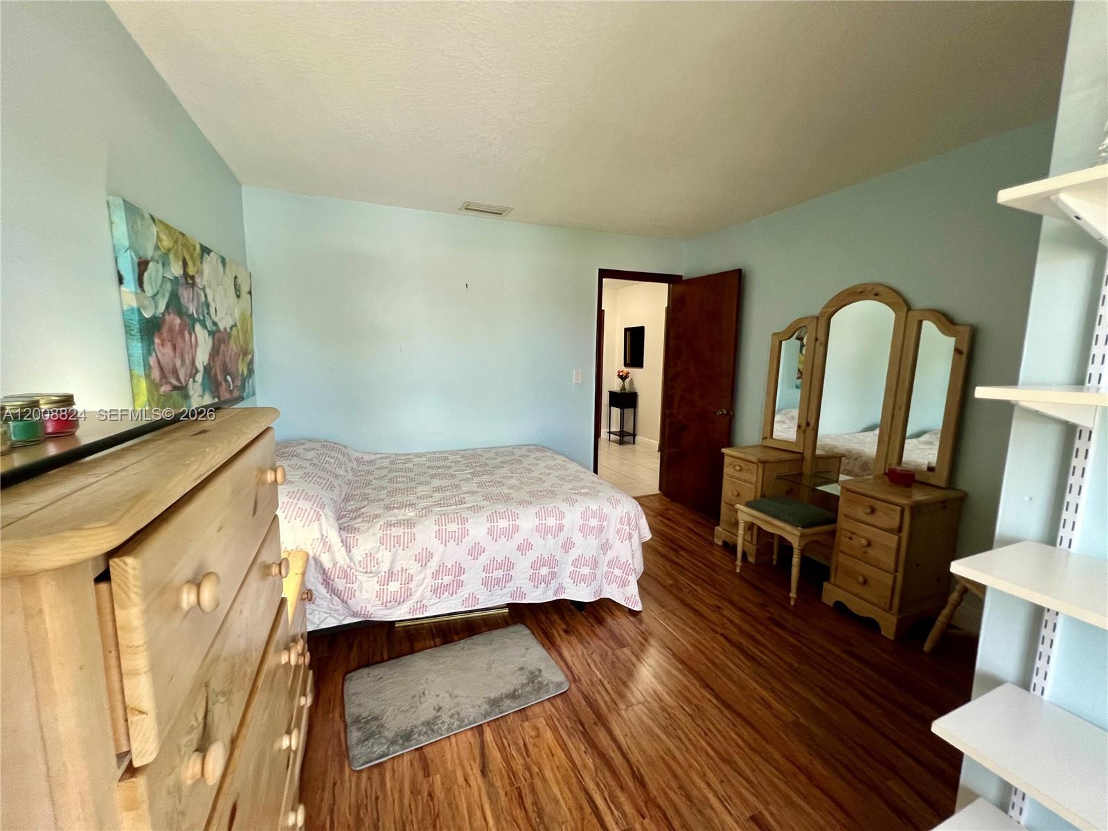 3610 Southwest 113th Place Miami, FL 33165 - Photo 33 of 49 a bedroom with a bed and wooden floor