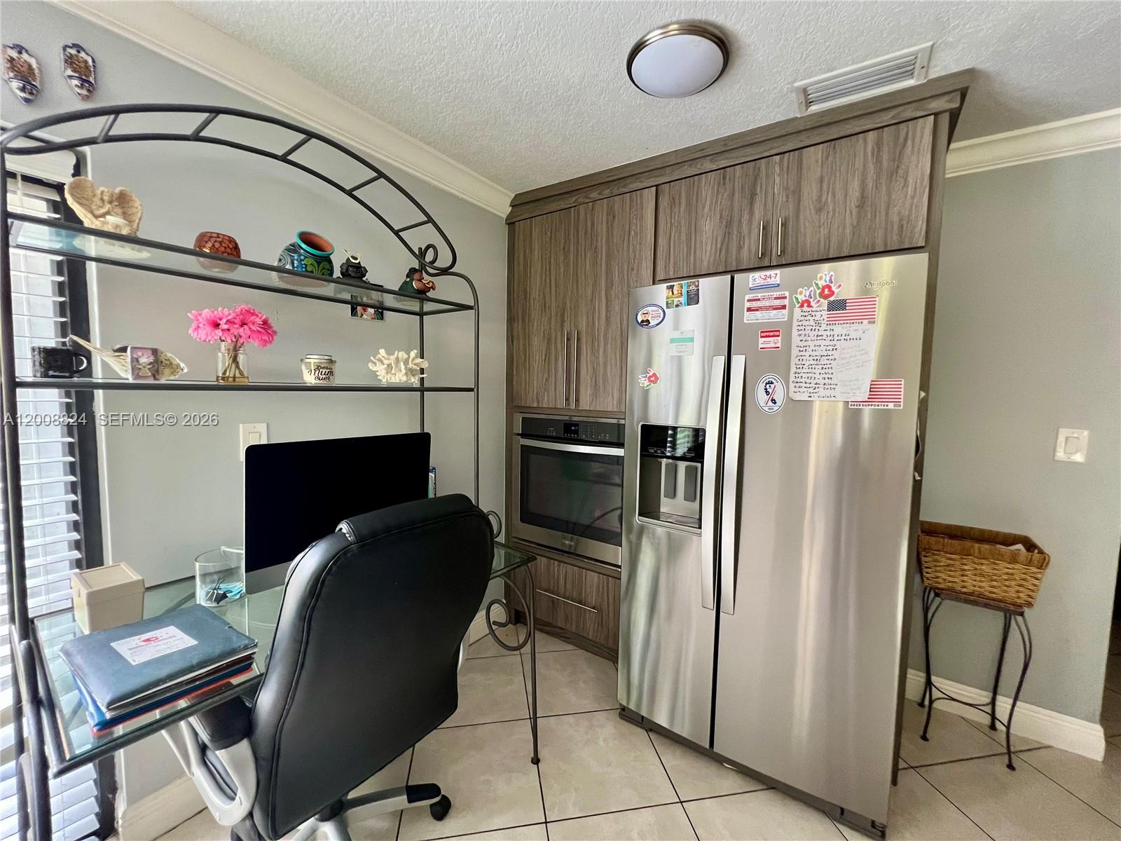 3610 Southwest 113th Place Miami, FL 33165 - Photo 8 of 49 a kitchen with a refrigerator and a stove top oven