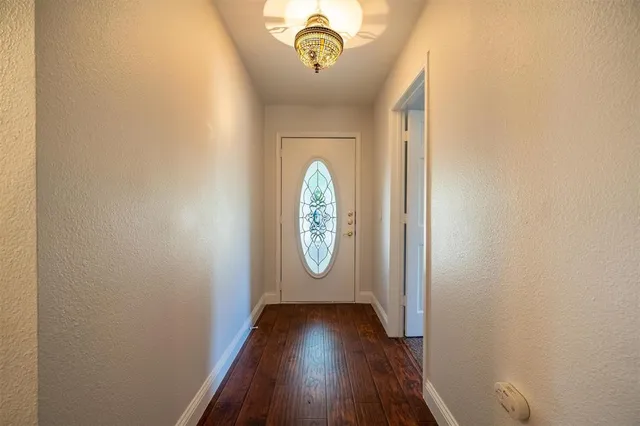 a view of hallway with wooden floor