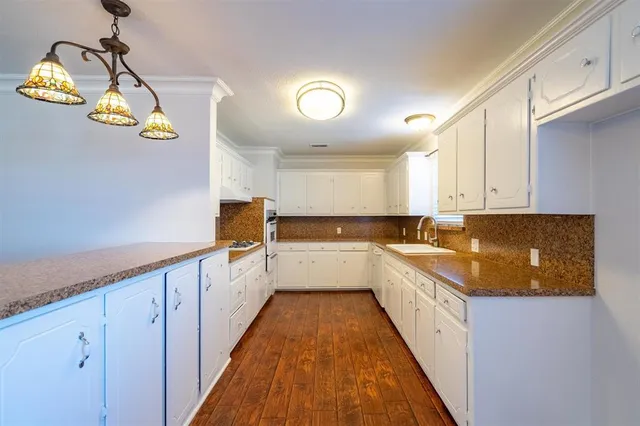 a bathroom with a granite countertop sink and a window