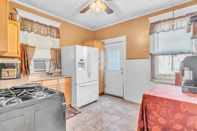a kitchen with a stove a refrigerator and a sink