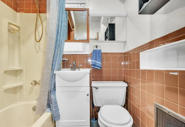 a bathroom with a toilet sink and shower