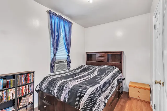 a bedroom with a bed and a book shelf