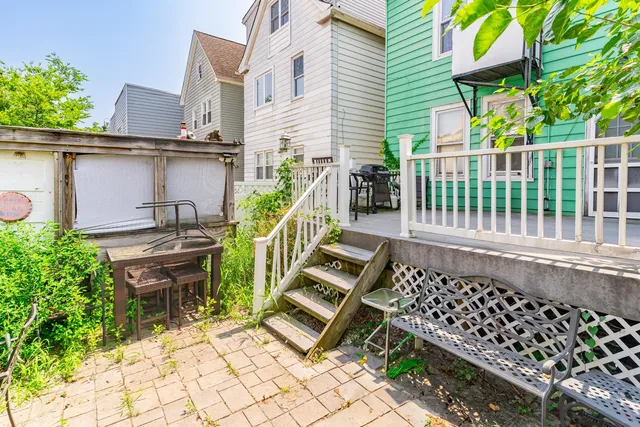 a view of a chairs and table in the balcony