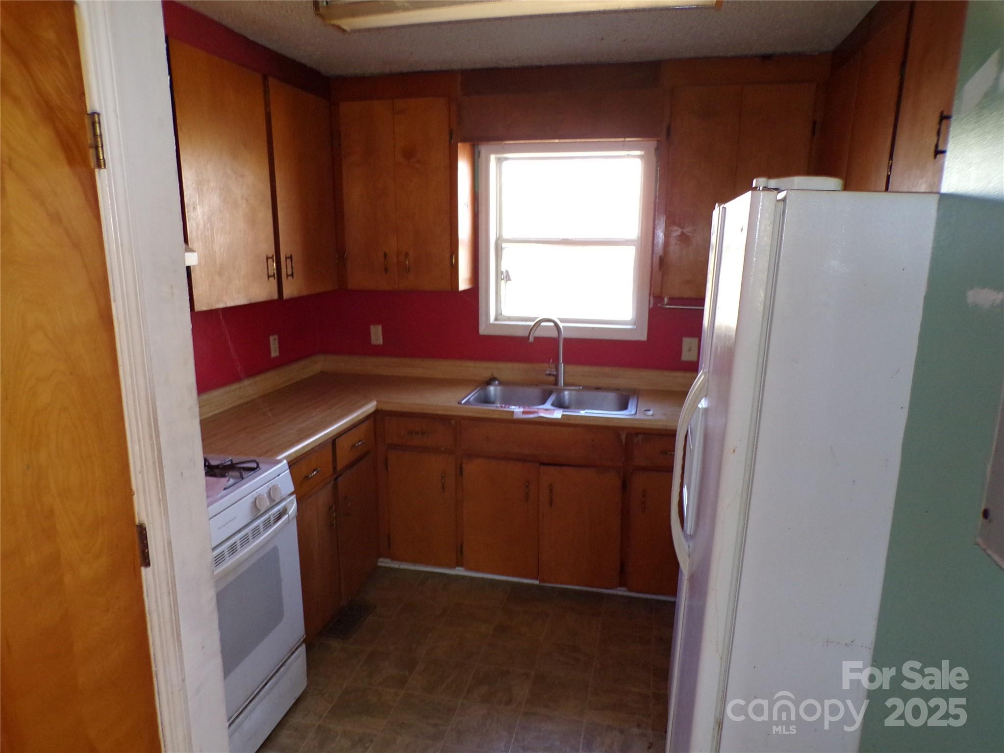 75 Bradley Turn Mill Spring, NC 28756 - Photo 16 of 20 a kitchen with a refrigerator and a sink