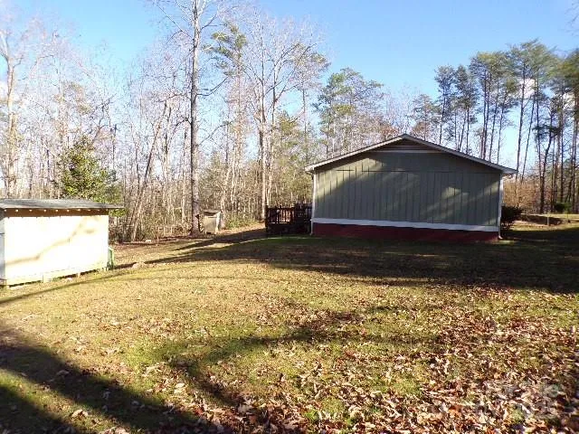 a view of house with backyard
