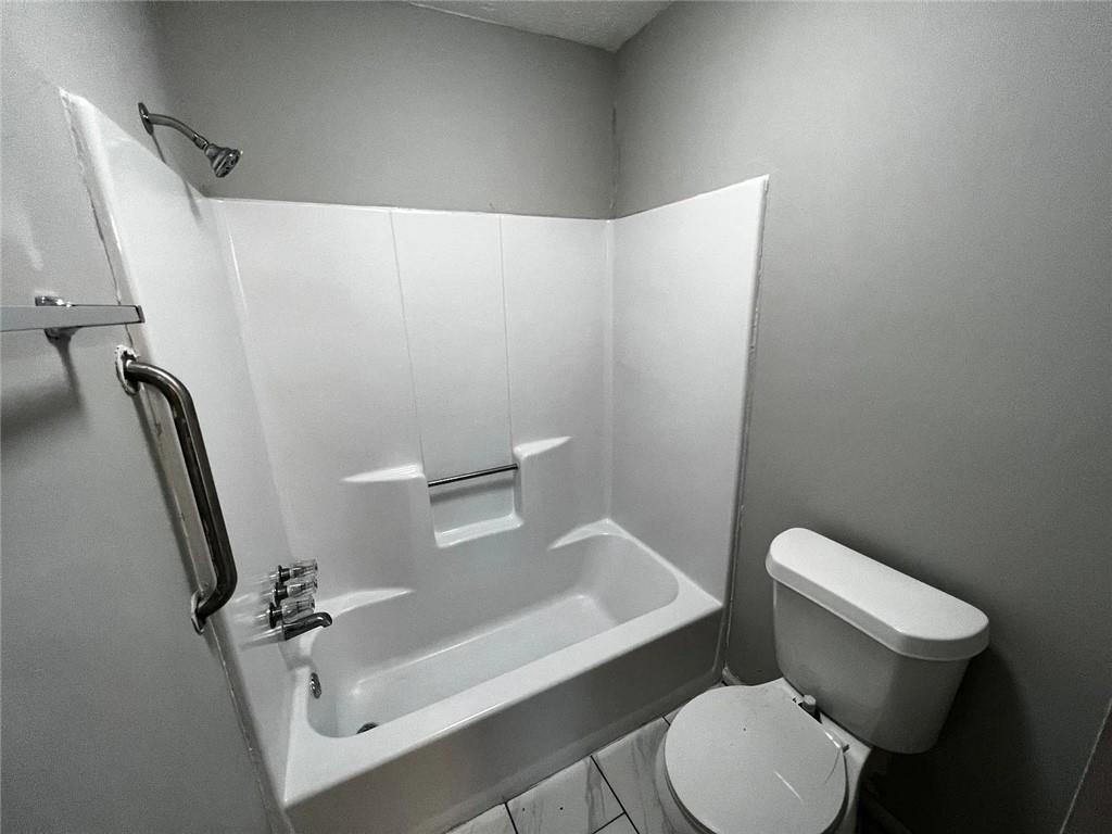 3932 Darryl Lane Gainesville, GA 30506 - Photo 13 of 34 a white toilet sitting next to a bath tub