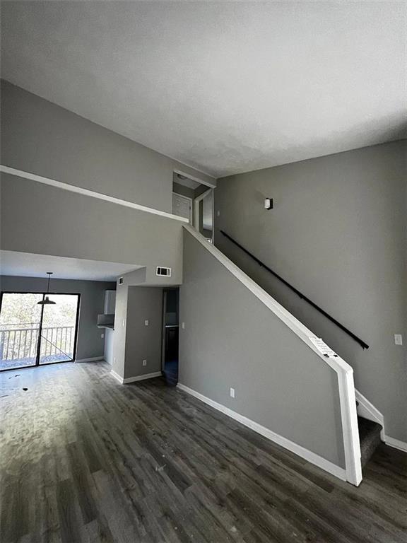 3932 Darryl Lane Gainesville, GA 30506 - Photo 18 of 34 a view of an empty room with wooden floor and kitchen