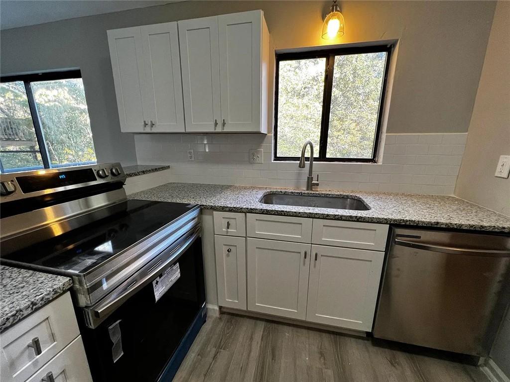 3932 Darryl Lane Gainesville, GA 30506 - Photo 10 of 34 a kitchen with a stove a sink and a window