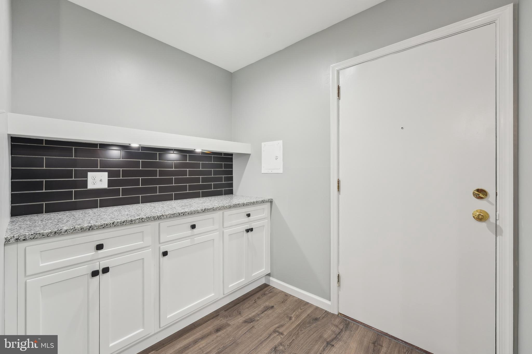 203 Drummers Lane, Unit 203 Wayne, PA 19087 - Photo 11 of 40 a kitchen with granite countertop white cabinets and white appliances
