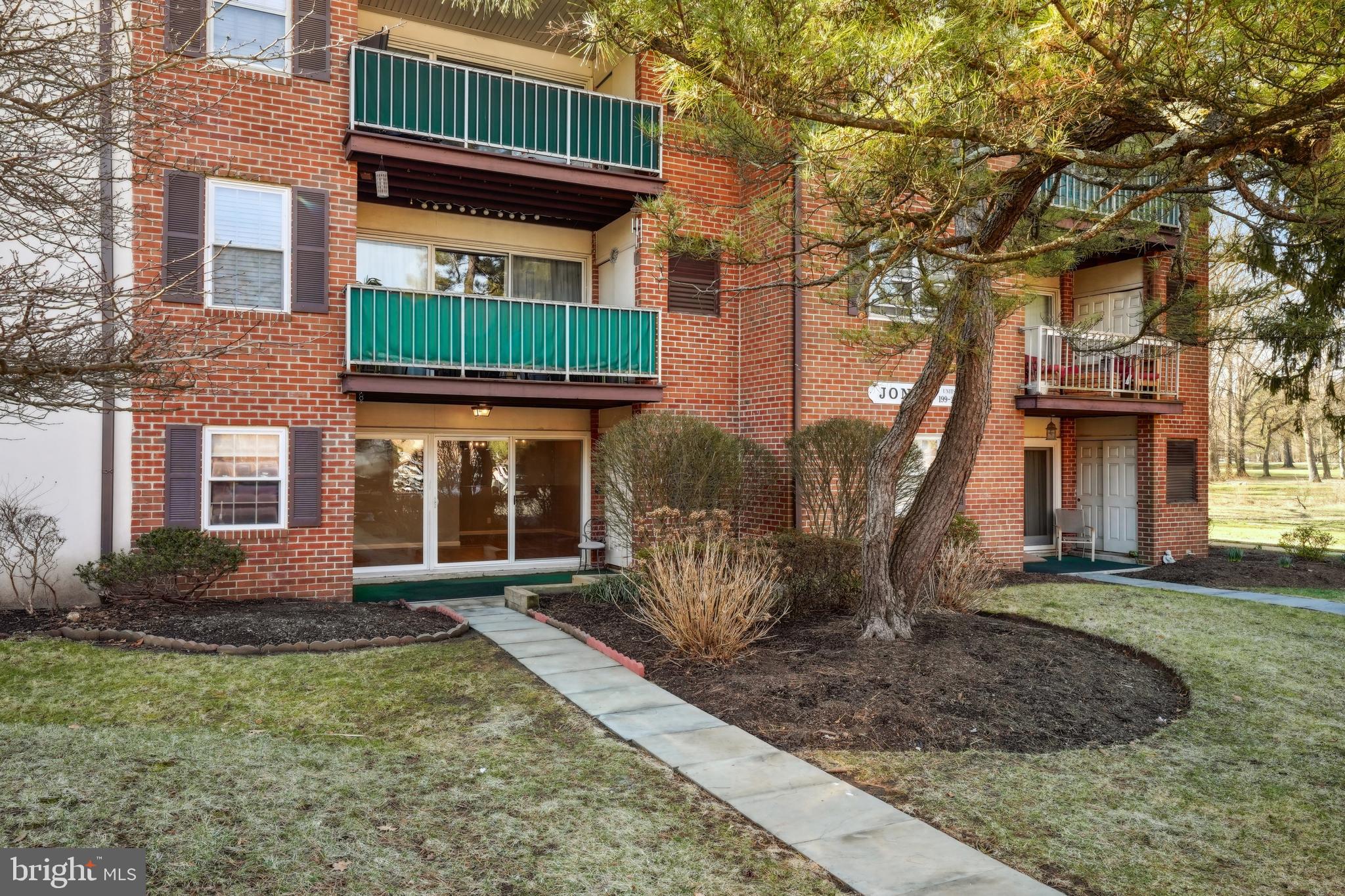 203 Drummers Lane, Unit 203 Wayne, PA 19087 - Photo 2 of 40 a front view of a house with garden