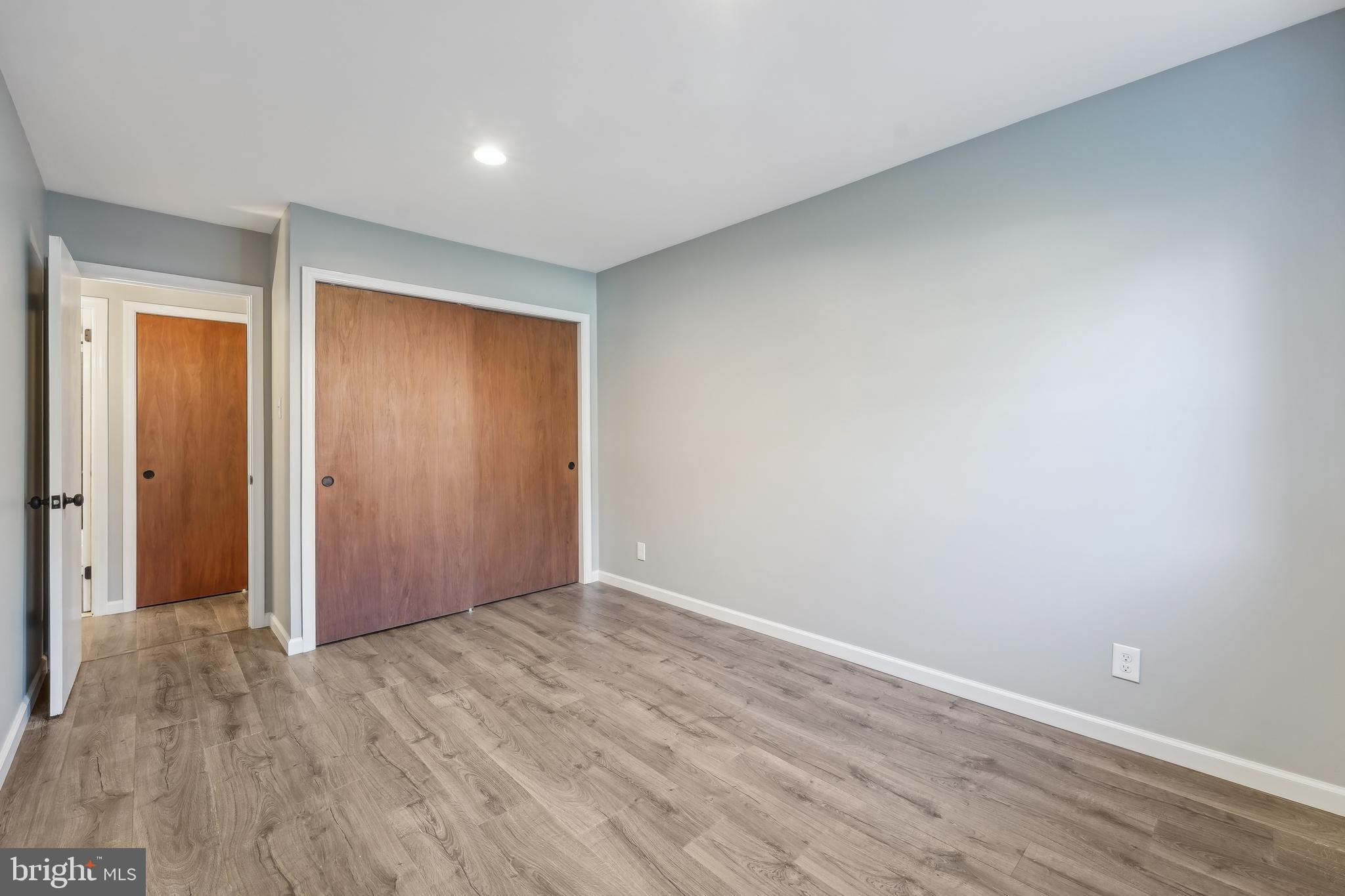 203 Drummers Lane, Unit 203 Wayne, PA 19087 - Photo 21 of 40 an empty room with wooden floor and closet