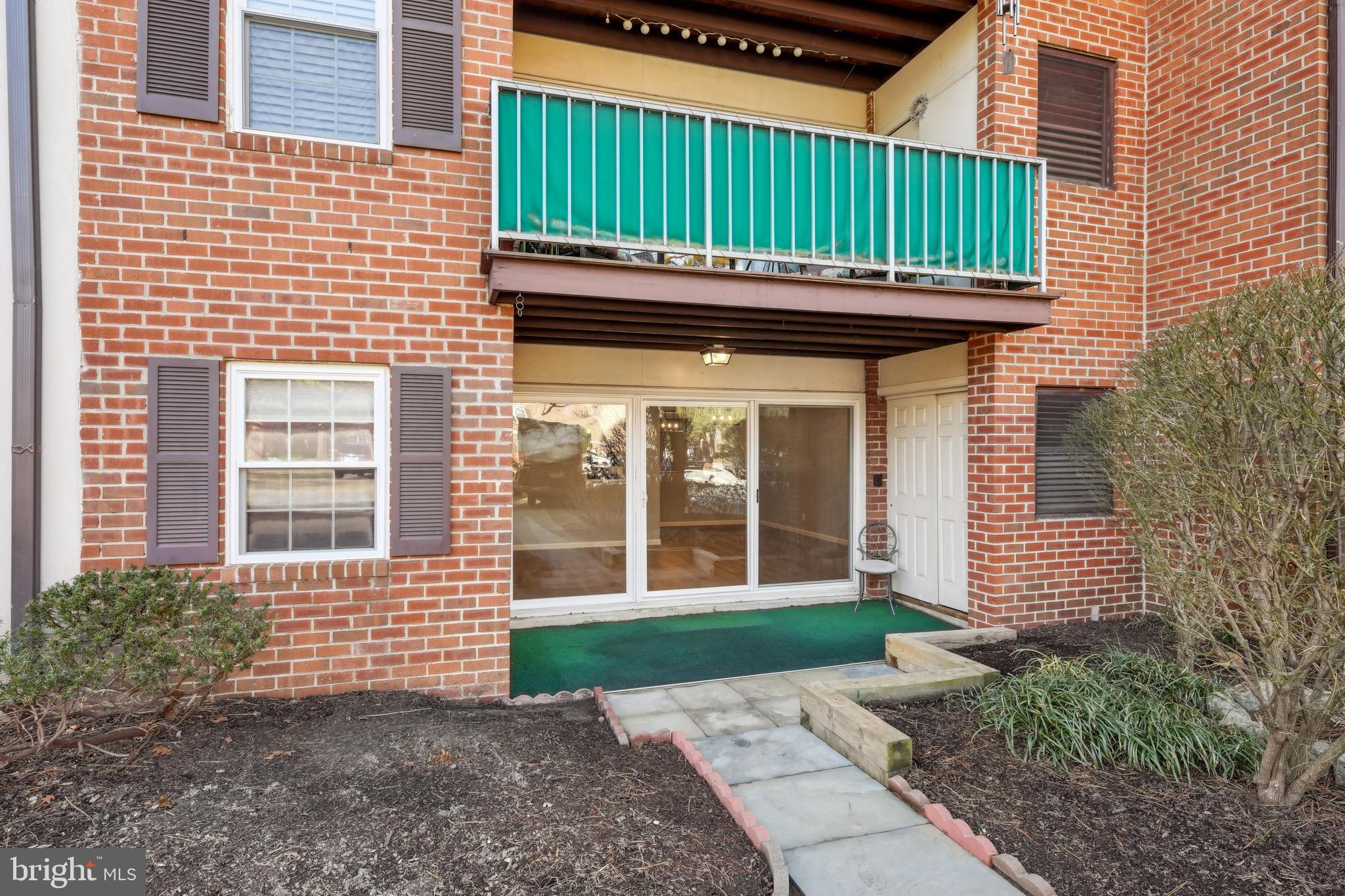 203 Drummers Lane, Unit 203 Wayne, PA 19087 - Photo 3 of 40 a view of a house with a yard and large trees