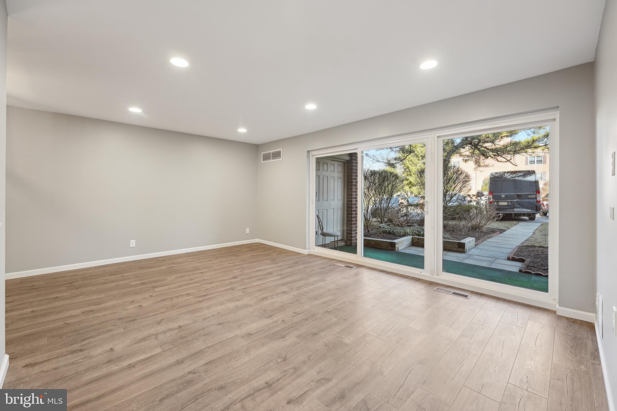 203 Drummers Lane, Unit 203 Wayne, PA 19087 - Photo 5 of 40 a view of room with wooden floor and floor to ceiling window