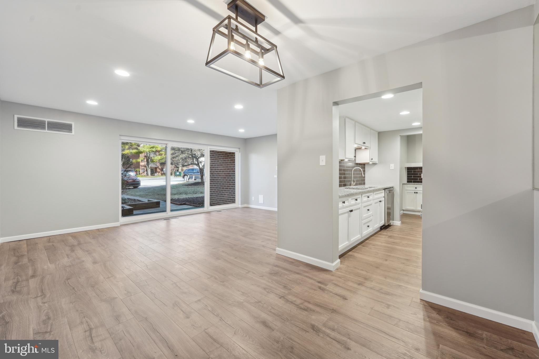 203 Drummers Lane, Unit 203 Wayne, PA 19087 - Photo 7 of 40 a view of a room with wooden floor and windows