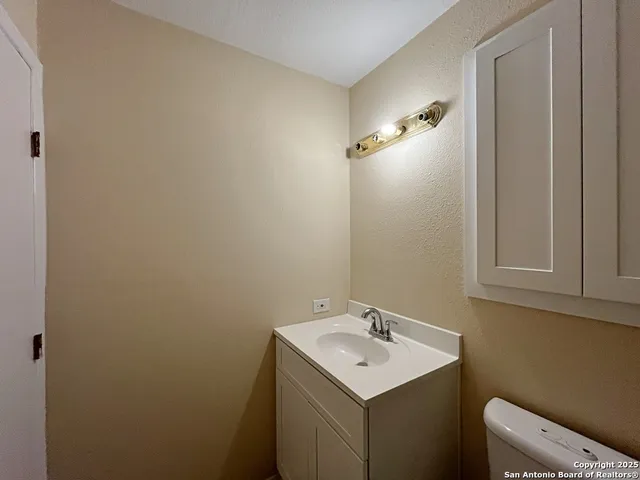 a bathroom with a sink toilet and vanity