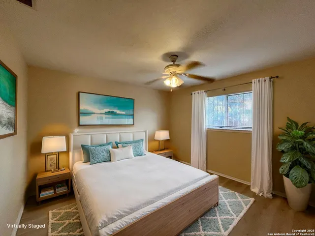 a bedroom with a bed and a potted plant