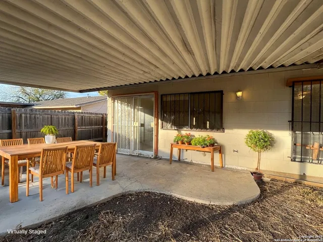 a living room with furniture a wooden floor and chandelier