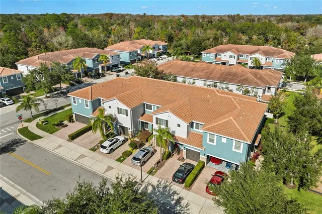 an aerial view of multiple houses with yard