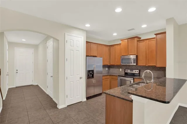 a kitchen with refrigerator and cabinets