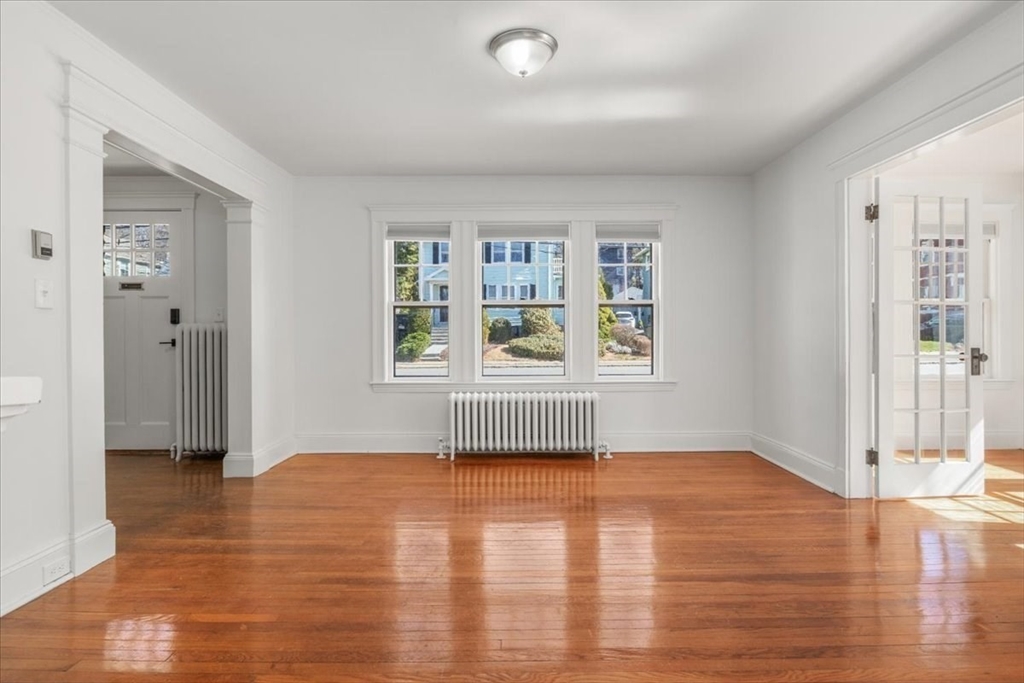 558 Lagrange Street, Unit 1 Boston, MA 02132 - Photo 16 of 40 wooden floor in an empty room with a window