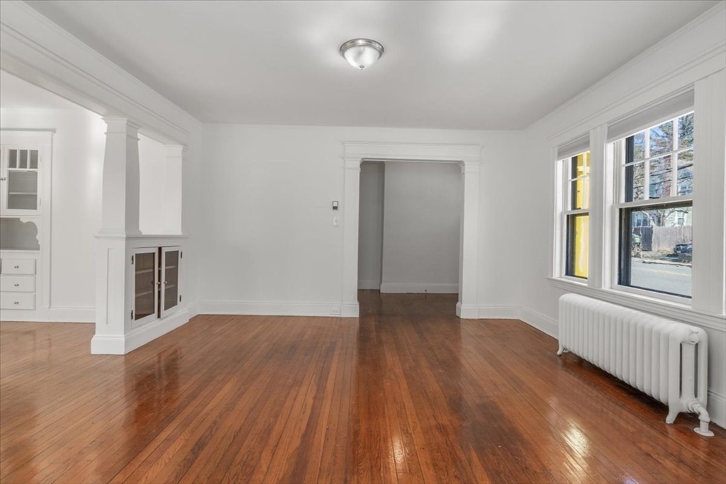 558 Lagrange Street, Unit 1 Boston, MA 02132 - Photo 18 of 40 wooden floor in an empty room with a window