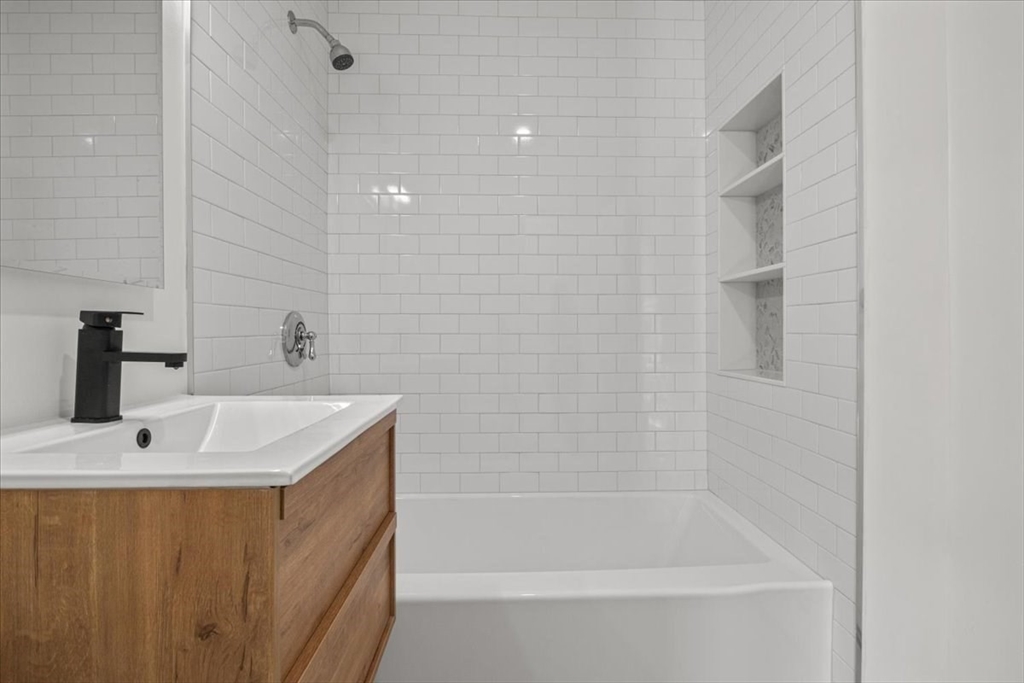 558 Lagrange Street, Unit 1 Boston, MA 02132 - Photo 25 of 40 a bath tub sitting next to a white sink