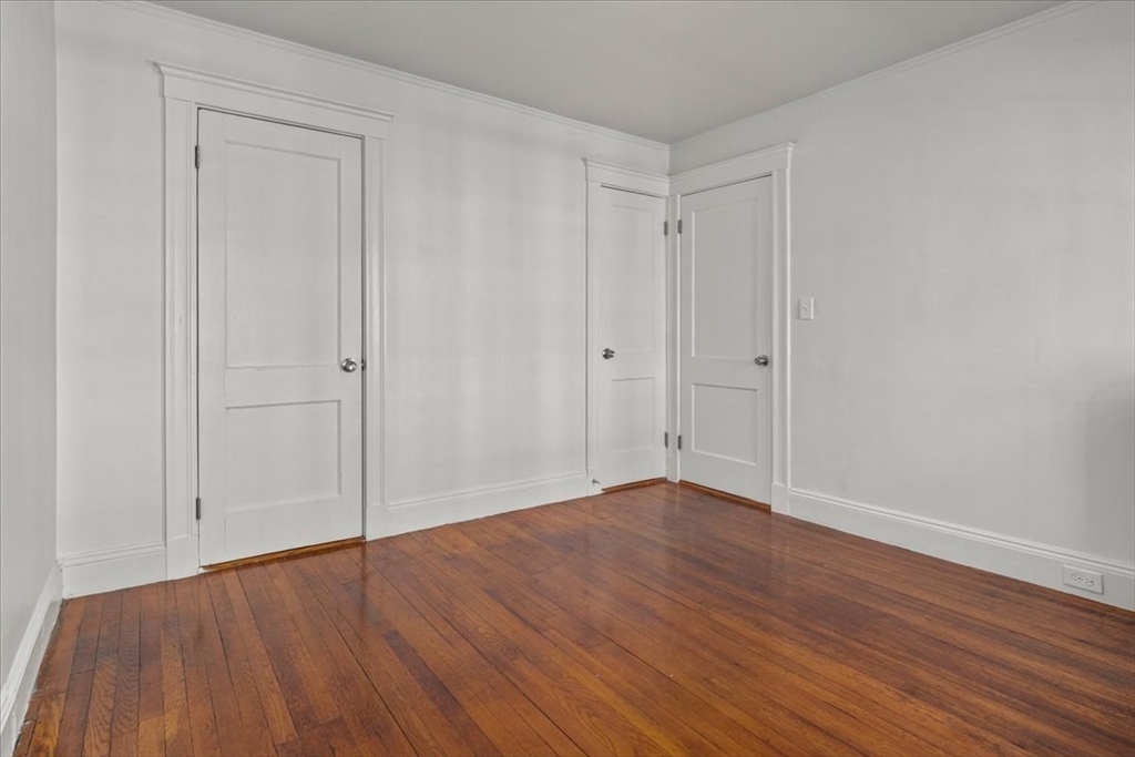 558 Lagrange Street, Unit 1 Boston, MA 02132 - Photo 30 of 40 a view of an empty room with wooden floor