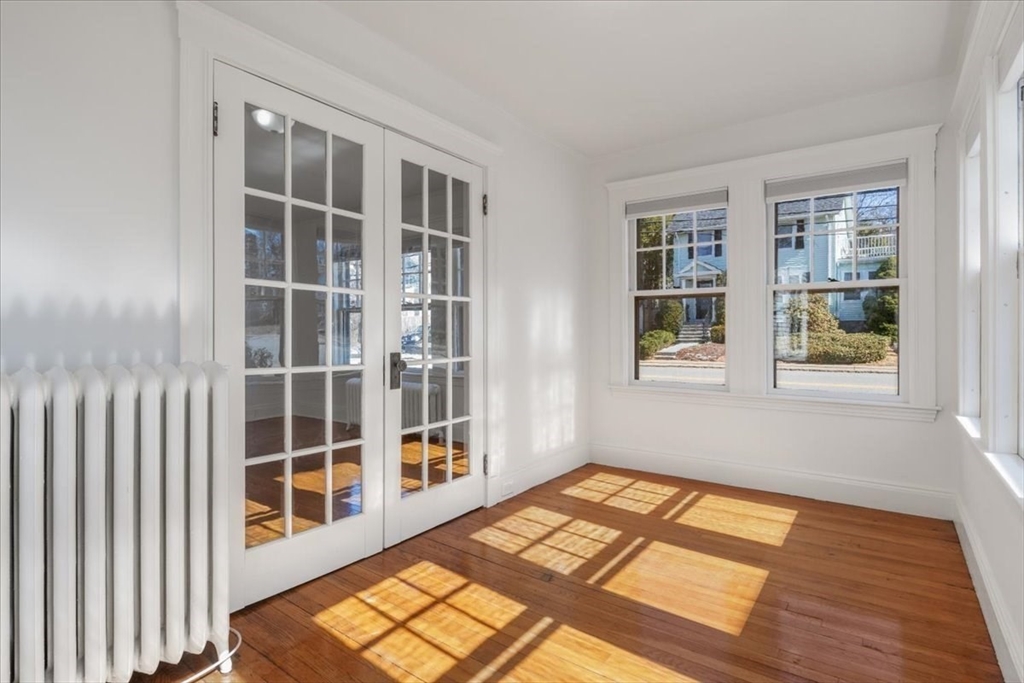 558 Lagrange Street, Unit 1 Boston, MA 02132 - Photo 3 of 40 a view of a room with wooden floor and windows