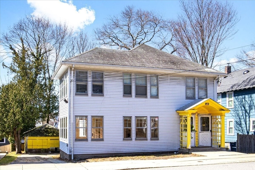 558 Lagrange Street, Unit 1 Boston, MA 02132 - Photo 38 of 40 a front view of a house with yard and trees