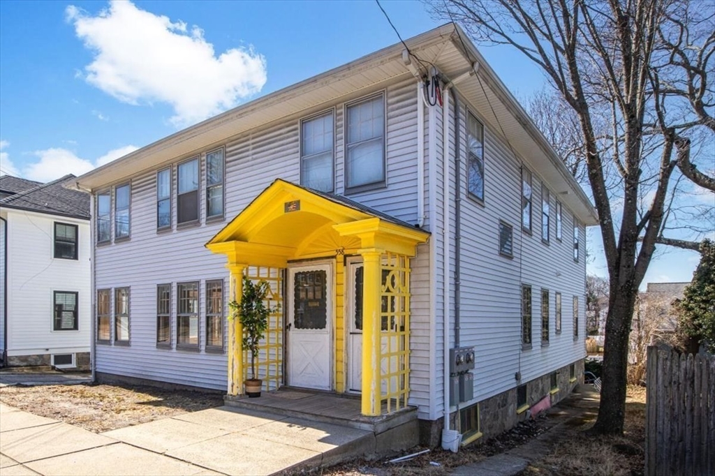 558 Lagrange Street, Unit 1 Boston, MA 02132 - Photo 40 of 40 a view of brick house with large windows