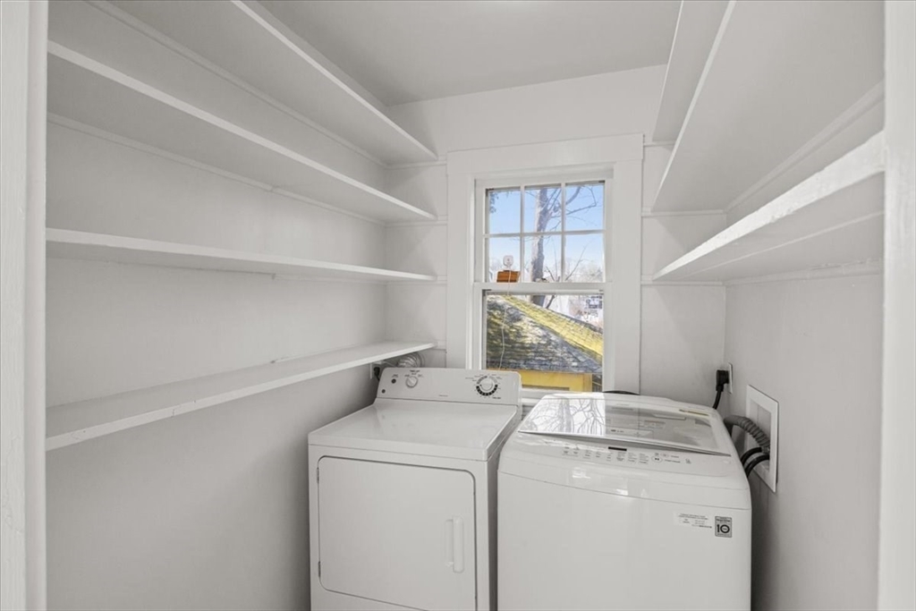 558 Lagrange Street, Unit 1 Boston, MA 02132 - Photo 6 of 40 a view of storage and utility room with washer and dryer