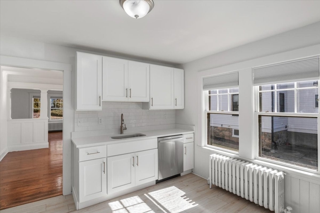 558 Lagrange Street, Unit 1 Boston, MA 02132 - Photo 8 of 40 a kitchen with a sink stove and cabinets
