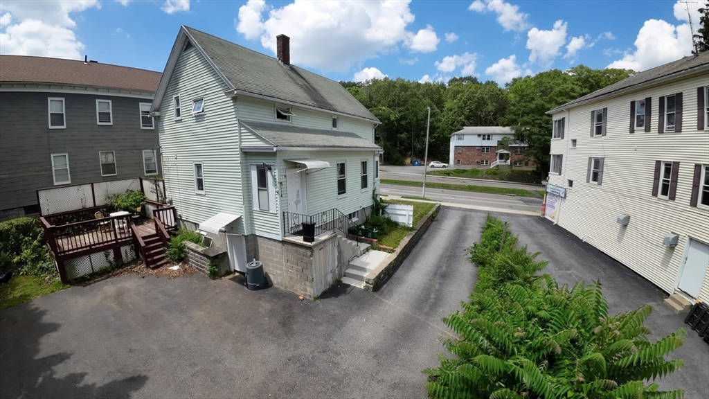 360 Hamilton Street Worcester, MA 01604 - Photo 5 of 35 a view of a patio with a table and chairs potted plants with wooden fence